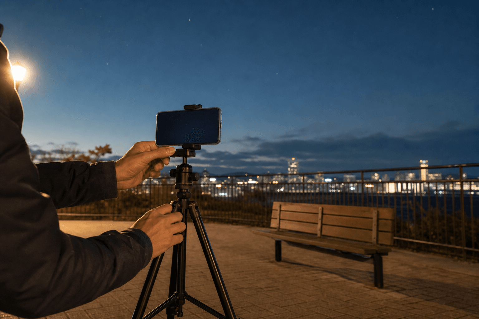 三脚に固定したスマートフォンで夜空の撮影準備をする様子